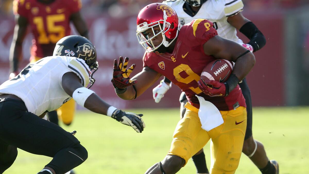 USC wide receiver JuJu Smith, right, tries to run past Colorado defensive back Chidobe Awuzie during the Trojans' victory Saturday.