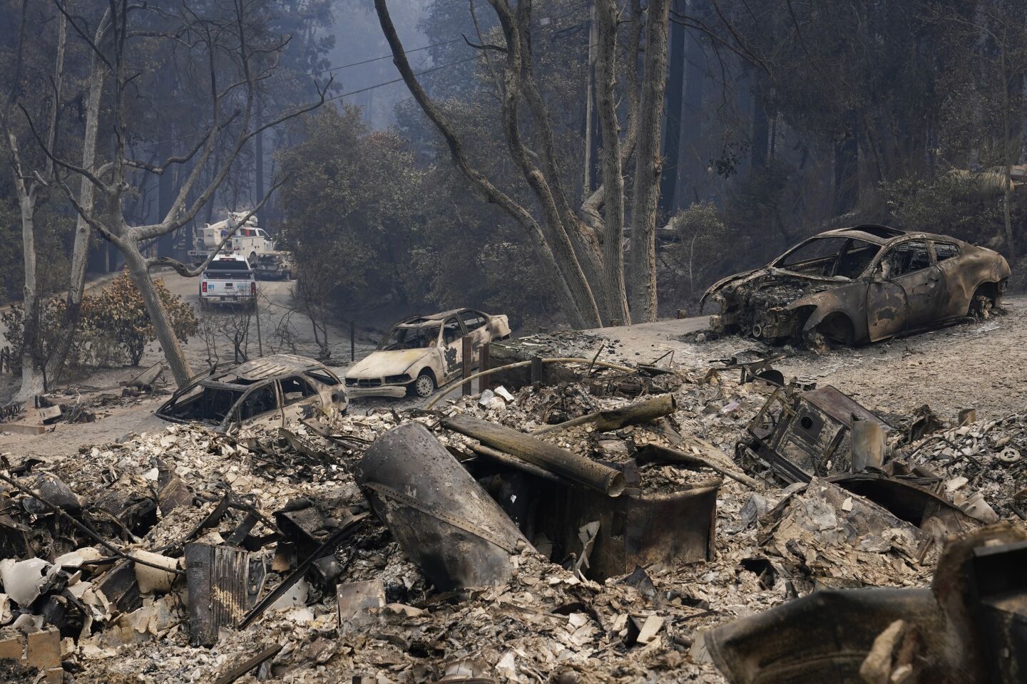 Burned vehicles and rubble from homes are left after the CZU Lightning Complex Fire tore through Sunday in Boulder Creek, Calif.