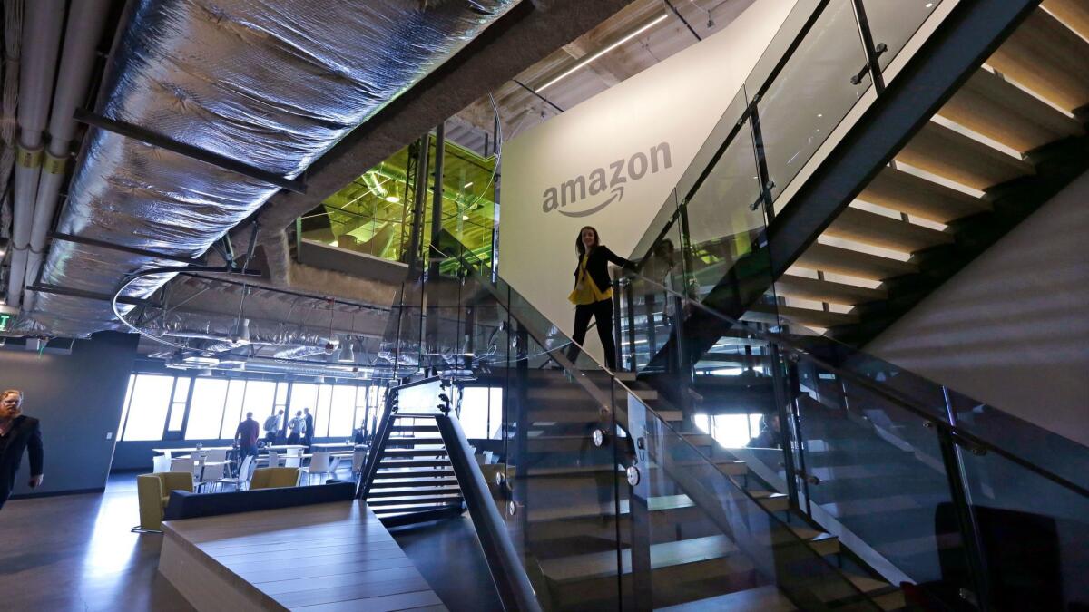 An Amazon worker walks down steps in the company's Seattle offices.