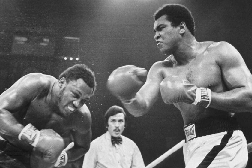 Muhammad Ali, right, and Joe Frazier fight for the third time on Oct. 1, 1975, during their "Thrilla in Manila."