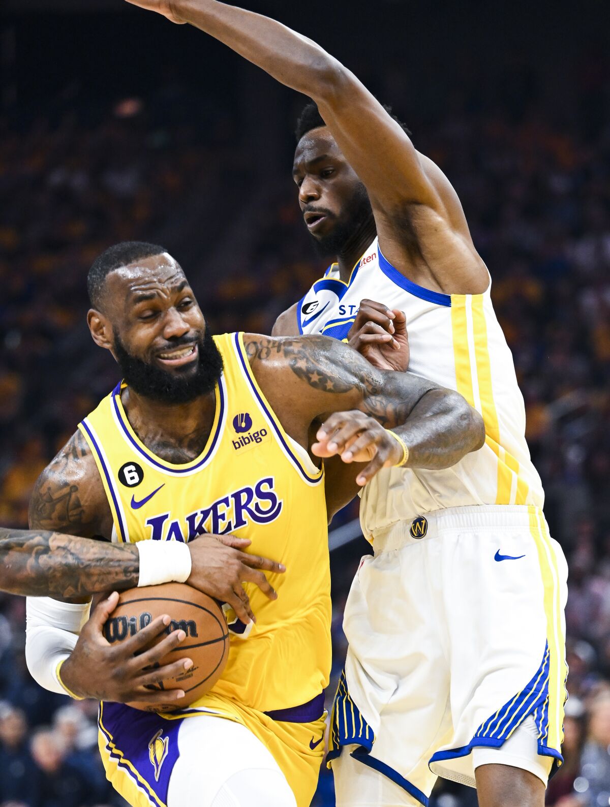 LeBron James takes on a Warriors forward.
