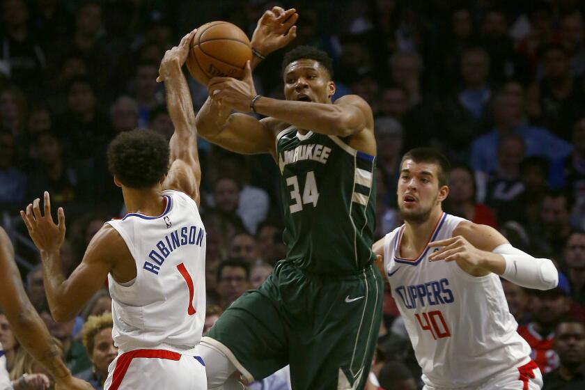 LOS ANGELES, CALIF. - NOV. 6, 2019. Clippers guard Giannis Anteokounmpo knocks the ball away from Bucks forward Thanasis Antetokounmpo as Clippers big man Ivaca Zubac defends in the second quarter at Staples Center in Los Angeles on Wednesday night, Nov. 6, 2019. (Luis Sinco/Los Angeles Times)
