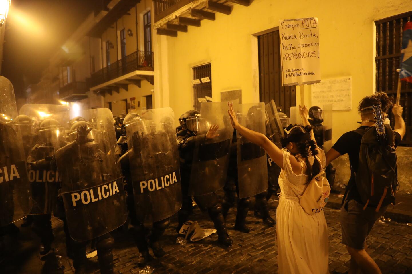 Police in riot gear advance on demonstrators during protests against Puerto Rico Gov. Ricardo Rossello in Old San Juan.