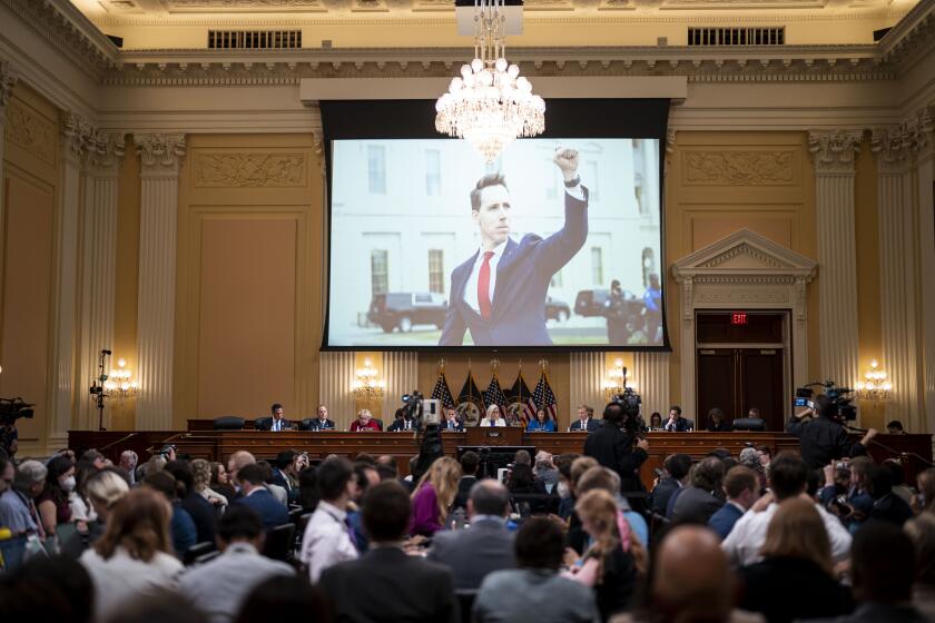 WASHINGTON, DC - JULY 21: A photograph of Sen. Josh Hawley (R-MO) from January 6 is seen on screen hearing of the House Select Committee to Investigate the January 6th Attack on the United States Capitol in the Cannon House Office Building on Thursday, July 21, 2022 in Washington, DC. The bipartisan Select Committee to Investigate the January 6th Attack On the United States Capitol has spent nearly a year conducting more than 1,000 interviews, reviewed more than 140,000 documents day of the attack. (Kent Nishimura / Los Angeles Times)