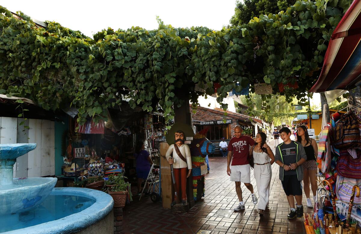 Visitors stroll along Olvera Street, part of downtown Los Angeles' El Pueblo de Los Angeles Historic Monument.