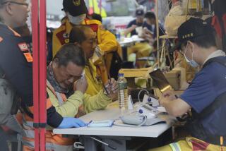Two trapped workers of Taroko National Park have a physical examination after being rescued in Hualien County, eastern Taiwan, Thursday, April 4, 2024. Rescuers are searching for dozens of people still missing a day after Taiwan’s strongest earthquake in a quarter century. (AP Photo/Chiang Ying-ying)