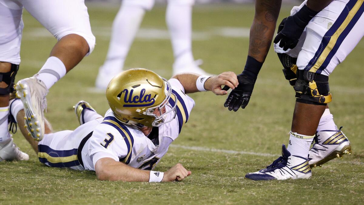UCLA quarterback Josh Rosen (3) gets some help after getting knocked to the ground during the second half of a game against Arizona State on Oct. 8.