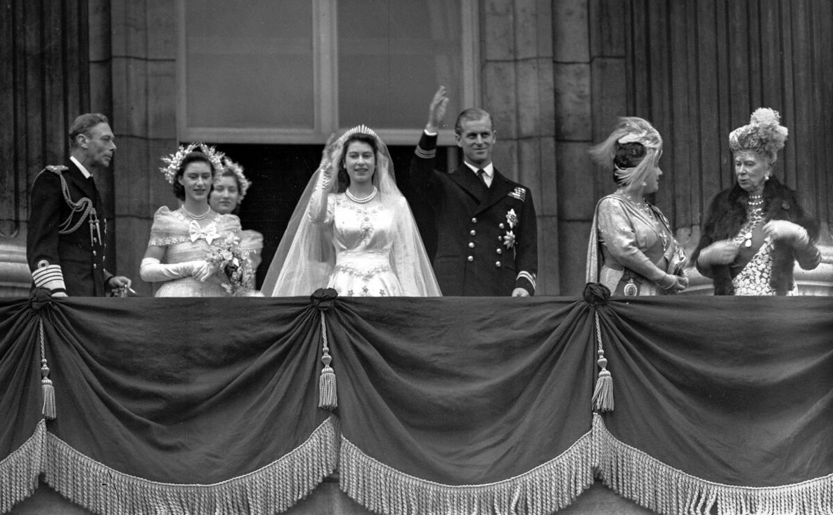 Nov. 20, 1947: Princess Elizabeth and Prince Philip wave to the crowd from the palace balcony. From left are, King George VI, Princess Margaret, Lady Mary Cambridge, the bride and bridegroom, Queen Elizabeth and Queen Mary, grandmother of the bride.