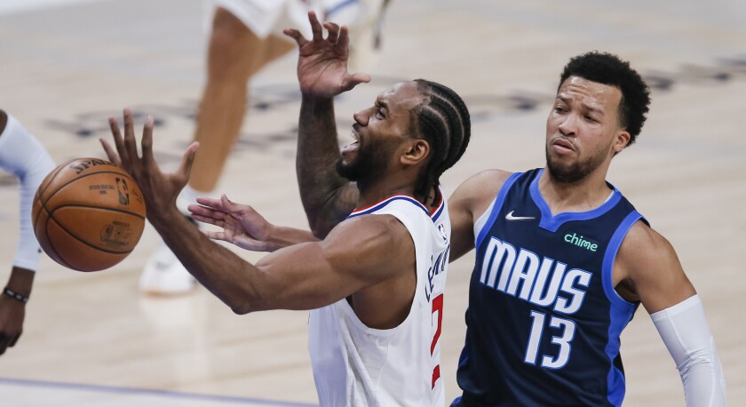 Dallas Mavericks guard Jalen Brunson fouls Clippers forward Kawhi Leonard.