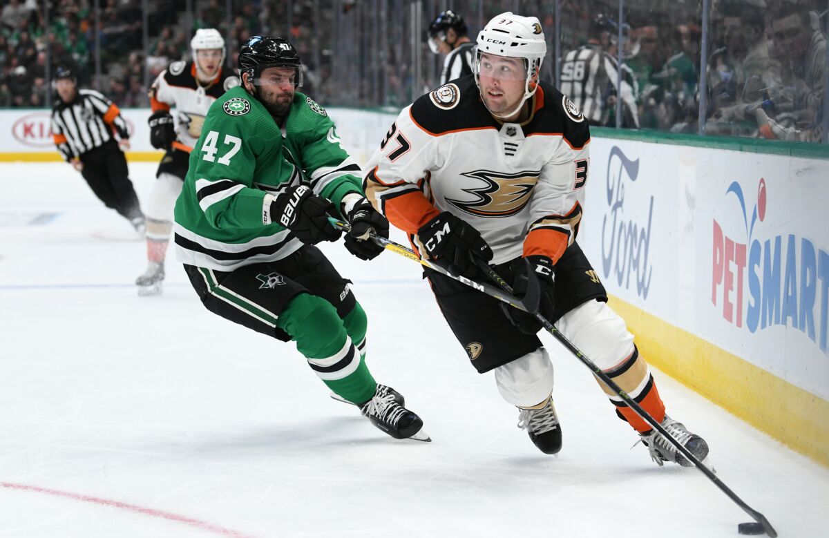 Ducks forward Nick Ritchie controls the puck ahead of Dallas Stars forward Alexander Radulov during the Ducks' 2-1 loss.