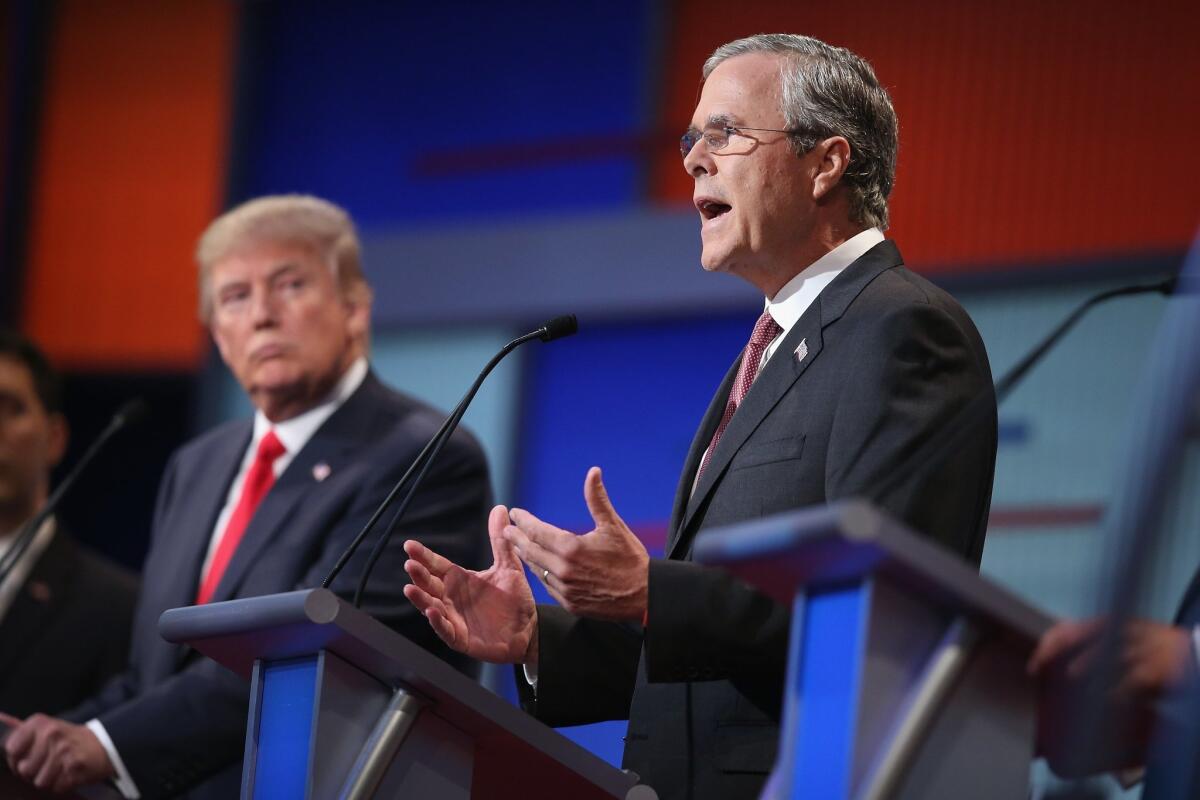 CLEVELAND, OH - AUGUST 06: Republican presidential candidate Donald Trump listens as Jeb Bush (R) fields a question during the first Republican presidential debate hosted by Fox News and Facebook at the Quicken Loans Arena on August 6, 2015 in Cleveland, Ohio. The top ten GOP candidates were selected to participate in the debate based on their rank in an average of the five most recent political polls. (Photo by Scott Olson/Getty Images) ** OUTS - ELSENT, FPG - OUTS * NM, PH, VA if sourced by CT, LA or MoD **