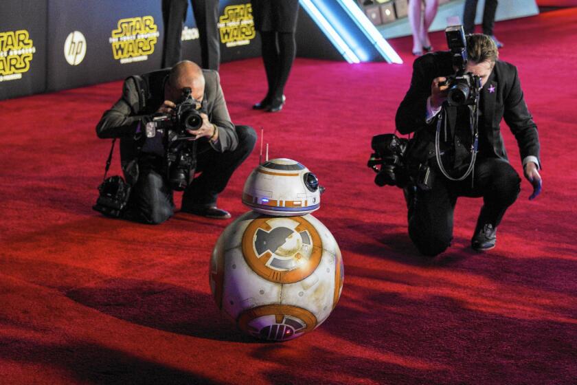 BB-8 is surrounded by photographers at the red-carpet Hollywood premiere of "Star Wars: The Force Awakens."