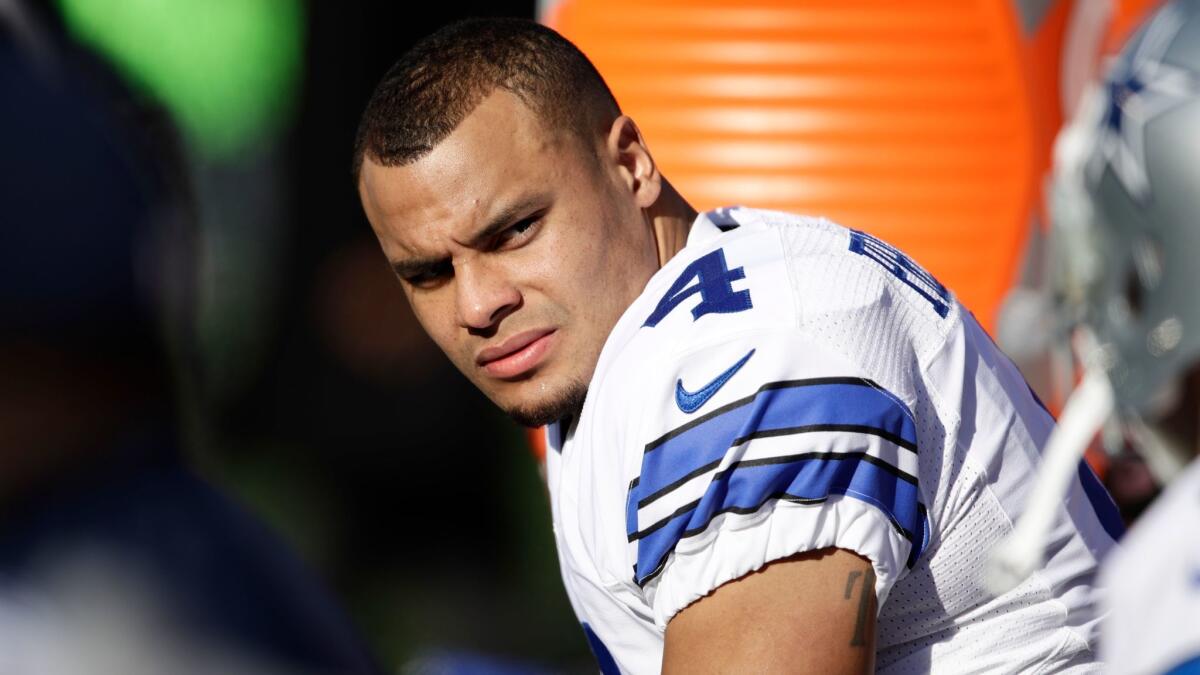 Dallas quarterback Dak Prescott watches from the bench during a game against Philadelphia on Jan. 1.