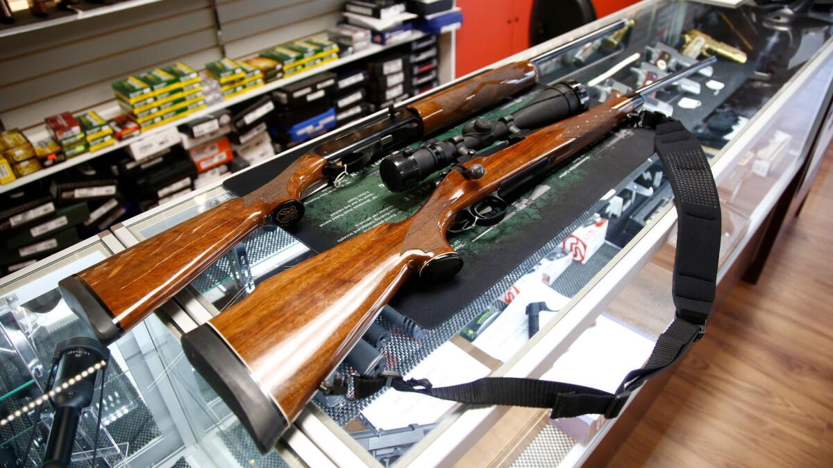 A Remington 700 hunting rifle and a Remington 1100 shotgun are displayed for sale at a North Carolina gun shop. Their manufacturer filed for bankruptcy protection on Monday.