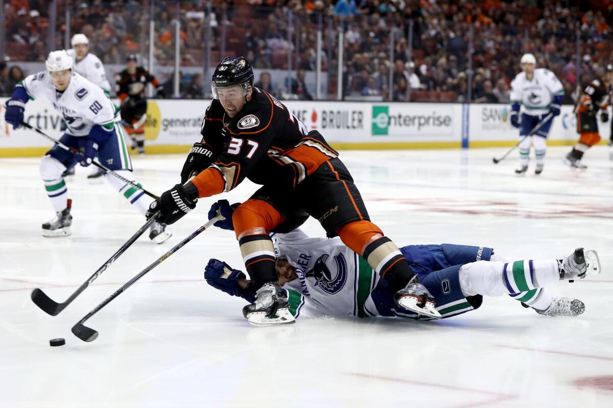 Forward Nick Ritchie (37) of the Ducks skates past Christopher Tanev of the Vancouver Canucks on Sunday.