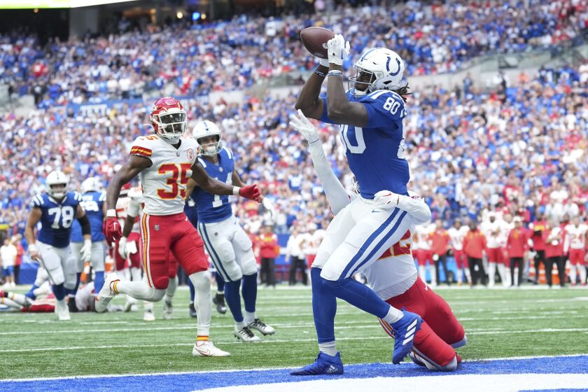 Indianapolis Colts tight end Jelani Woods (80) makes a touchdown reception against Kansas City Chiefs' Juan Thornhill during the second half of an NFL football game, Sunday, Sept. 25, 2022, in Indianapolis. (AP Photo/AJ Mast)
