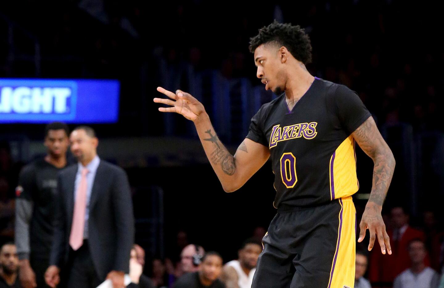 Lakers guard Nick Young celebrates after scoring a three-pointer against the Heat during the second quarter.