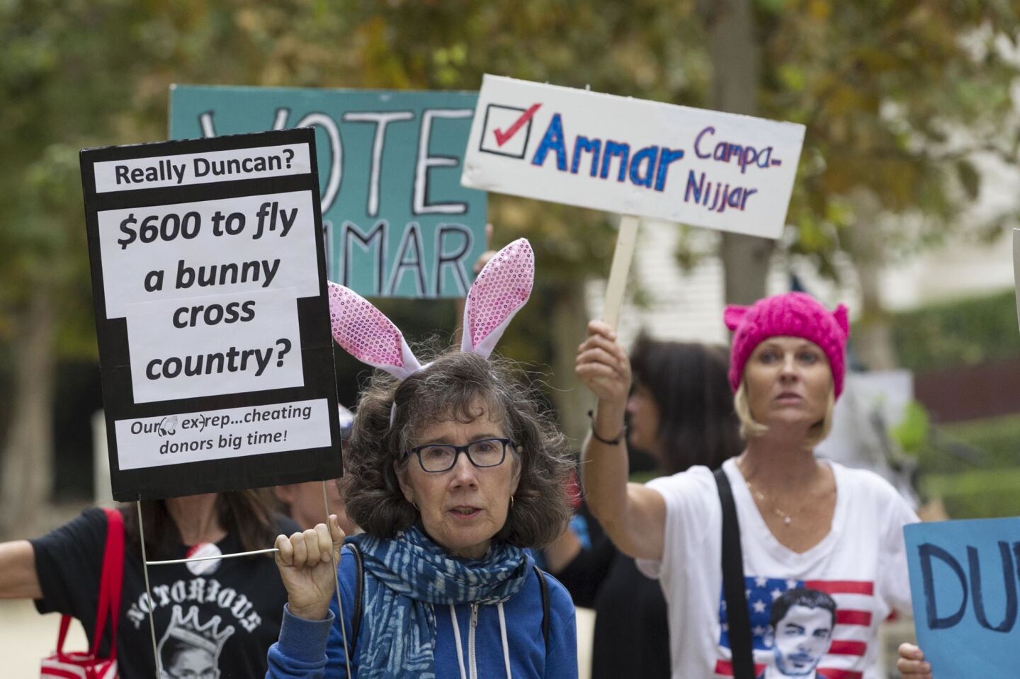 L-r, Judy Harrington and Candy Smiley protested outside the courthouse where Rep. Duncan Hunter Jr. appeared in Federal Court in San Diego on Monday, Sept. 24 for a status hearing on his case.
