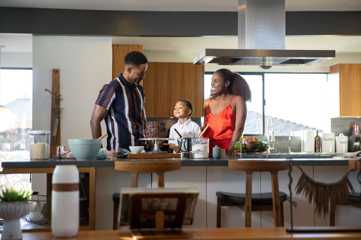 A couple and a child in the kitchen