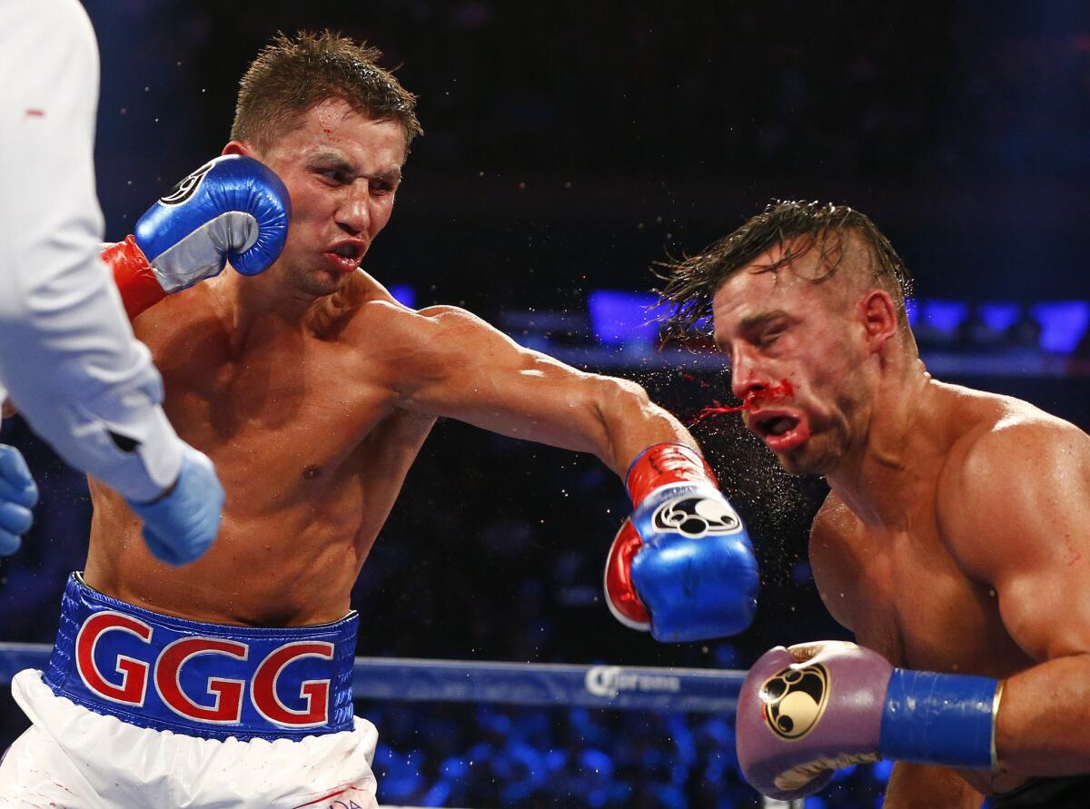 Gennady Golovkin staggers David Lemieux with a left to the head in the eighth round of their middleweight title unification fight at Madison Square Garden in New York on Saturday.