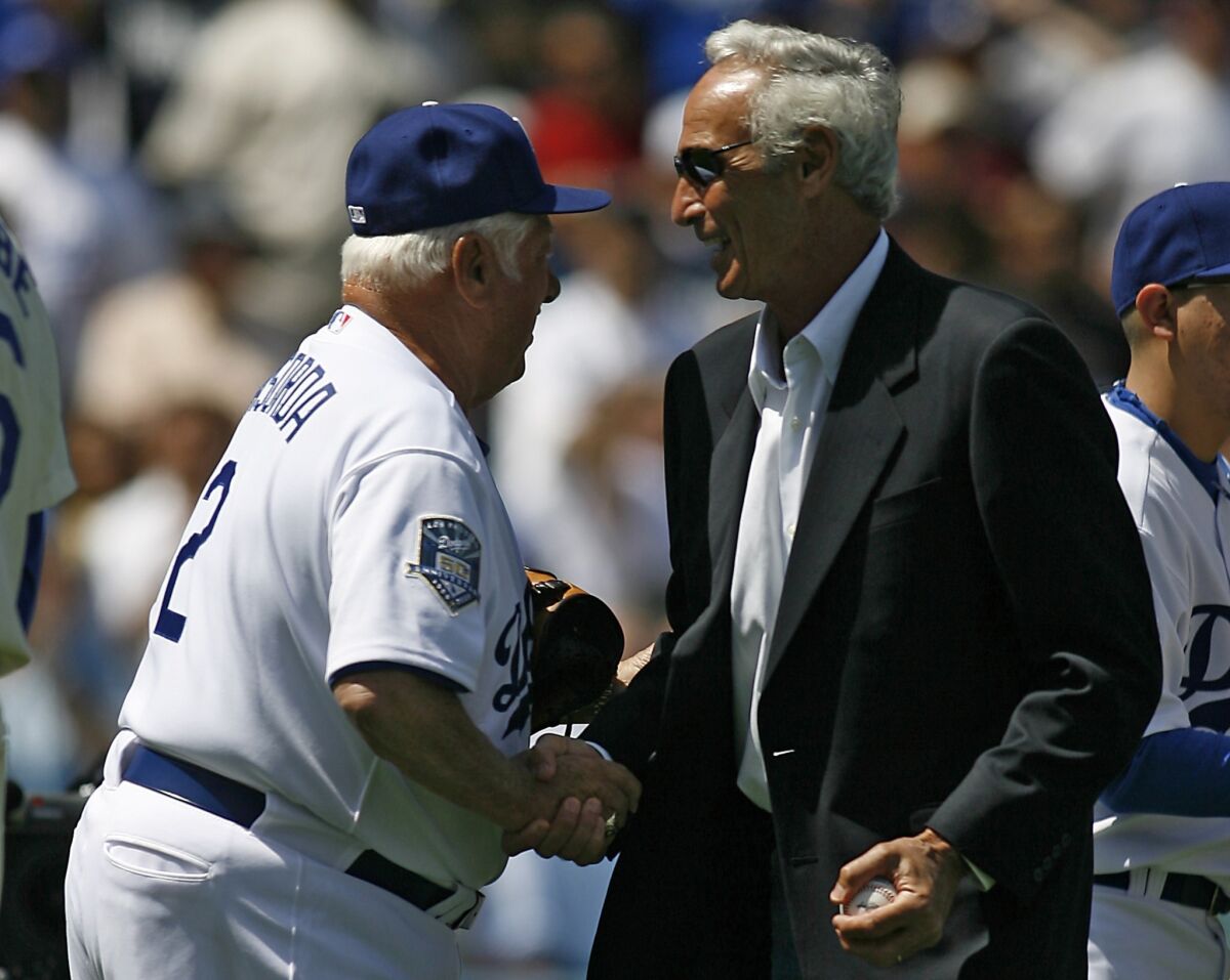 Former Dodgers manager Tommy Lasorda, left, shakes hands with legendary pitcher Sandy Koufax before the 2008 season opener.