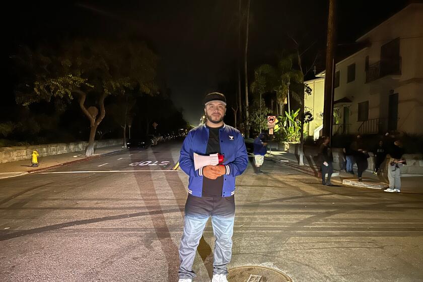Activist Edin Alex Enamorado stands at an empty Santa Barbara intersection 