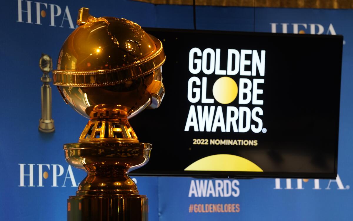 A golden trophy positioned in front of a TV screen that reads "Golden Globe Awards"