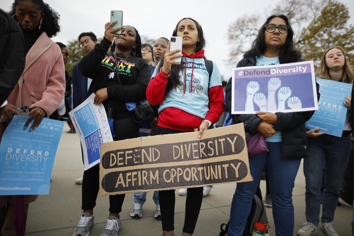 Protesters with pro-affirmative-action signs, including "Defend diversity, affirm opportunity." 