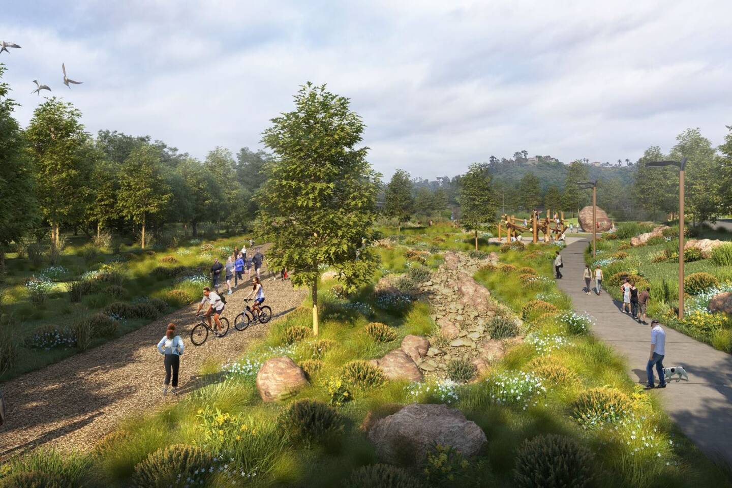 A rendering of the eastern portion of the park, looking south, with a natural path running adjacent to Murphy Canyon Creek. A portion of the hike and path that loops around the Mission Valley property is also shown. In the background, a kids' play area features nature-inspired equipment.