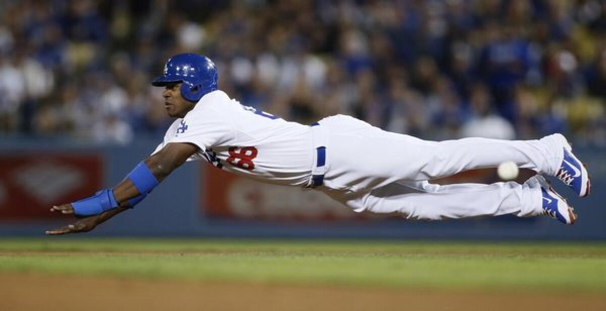 Dodgers right fielder Yasiel Puig dives for second base before he's tagged out on a stolen base attempt during Game 4 of the National League division series on Monday. Puig keeps it simple when speaking to reporters.