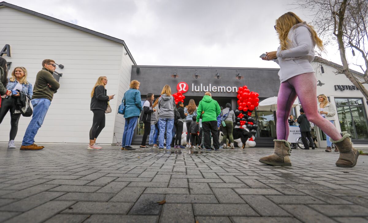 Customers wait in a line outside the new Lululemon store at One Paseo in Carmel Valley.