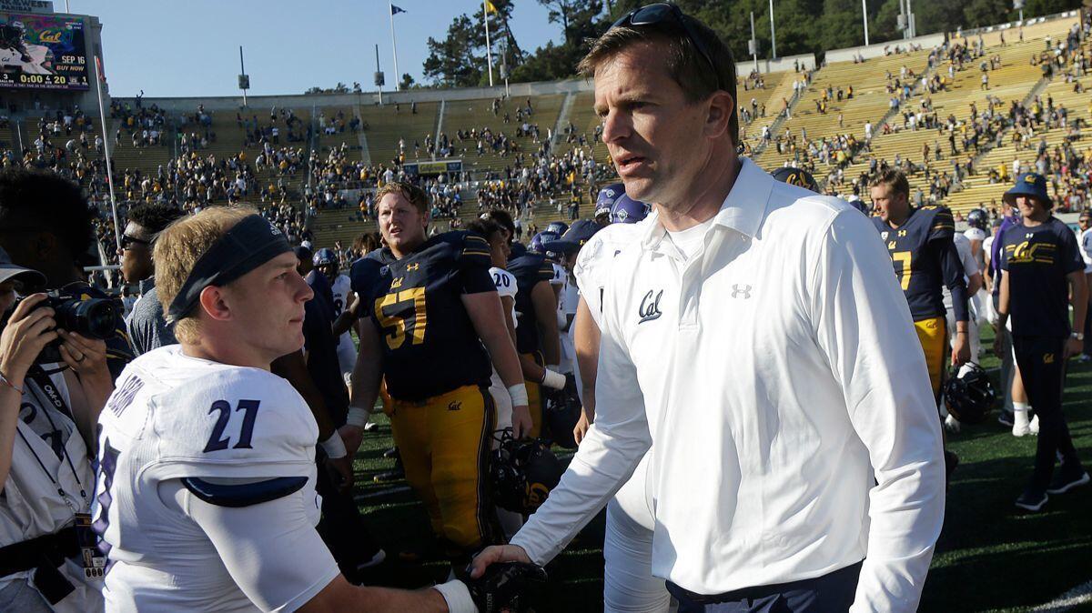California head coach Justin Wilcox, right, shakes hands with Weber State safety Jantz Arbon after their game on Sept. 9. California won 33-20.