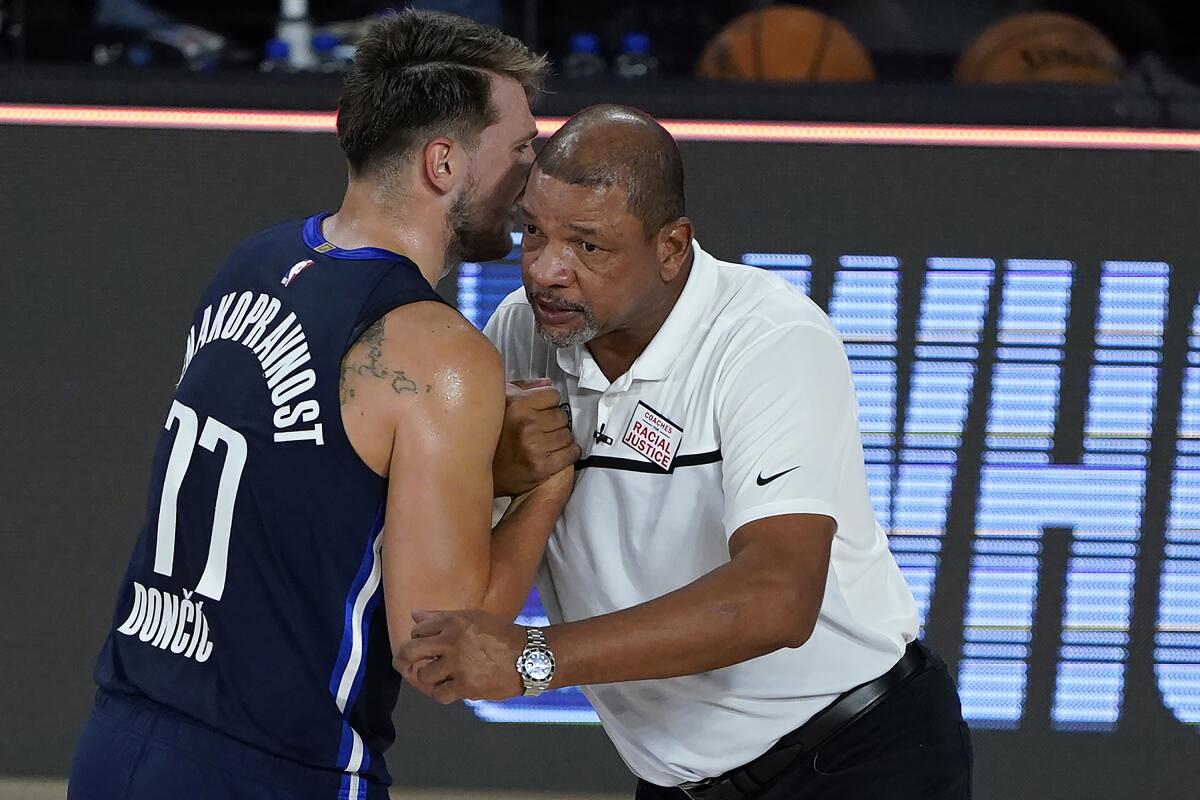 Dallas Mavericks star Luka Doncic speaks with Clippers coach Doc Rivers after a game on Aug. 6.