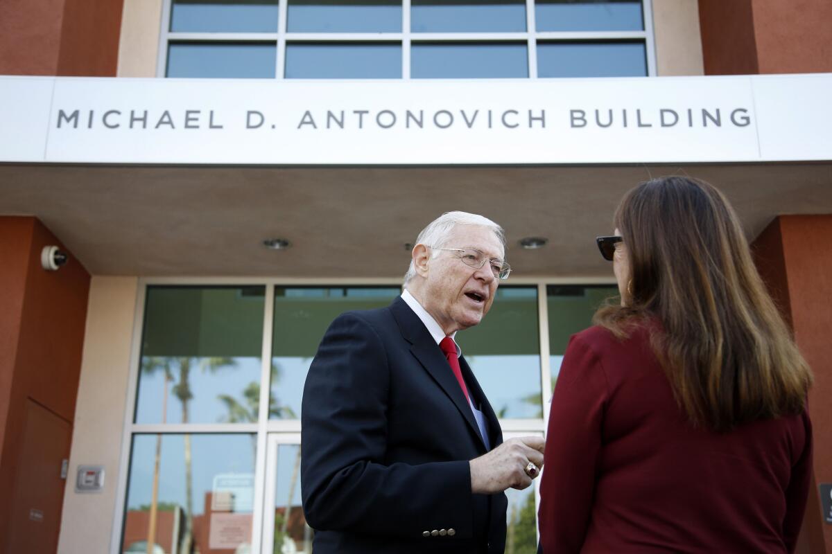 Los Angeles County Supervisor Michael D. Antonovich talks with Laura Ornest, a Didi Hirsch Mental Health Services board member, Wednesday outside the mental health services center that was renamed to honor the supervisor.
