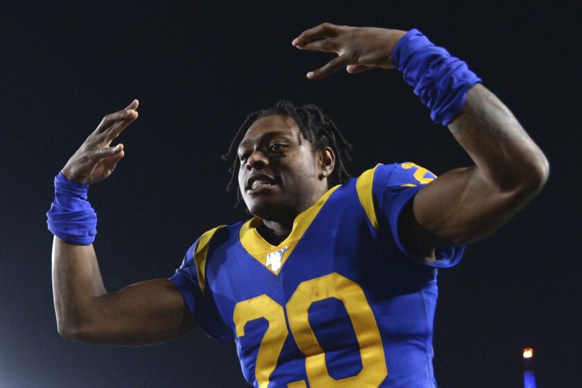 FILE - In this Nov. 17, 2019, file photo, Los Angeles Rams cornerback Jalen Ramsey celebrates the team's win over the Chicago Bears in an NFL football game in Los Angeles. Ramsey says he won’t hold out as he heads into the final year of his rookie contract and his first full season with the Rams. After a tumultuous tenure in Jacksonville, the star cornerback sounds content in Los Angeles and eager to play new roles on defense. (AP Photo/Kyusung Gong, File)