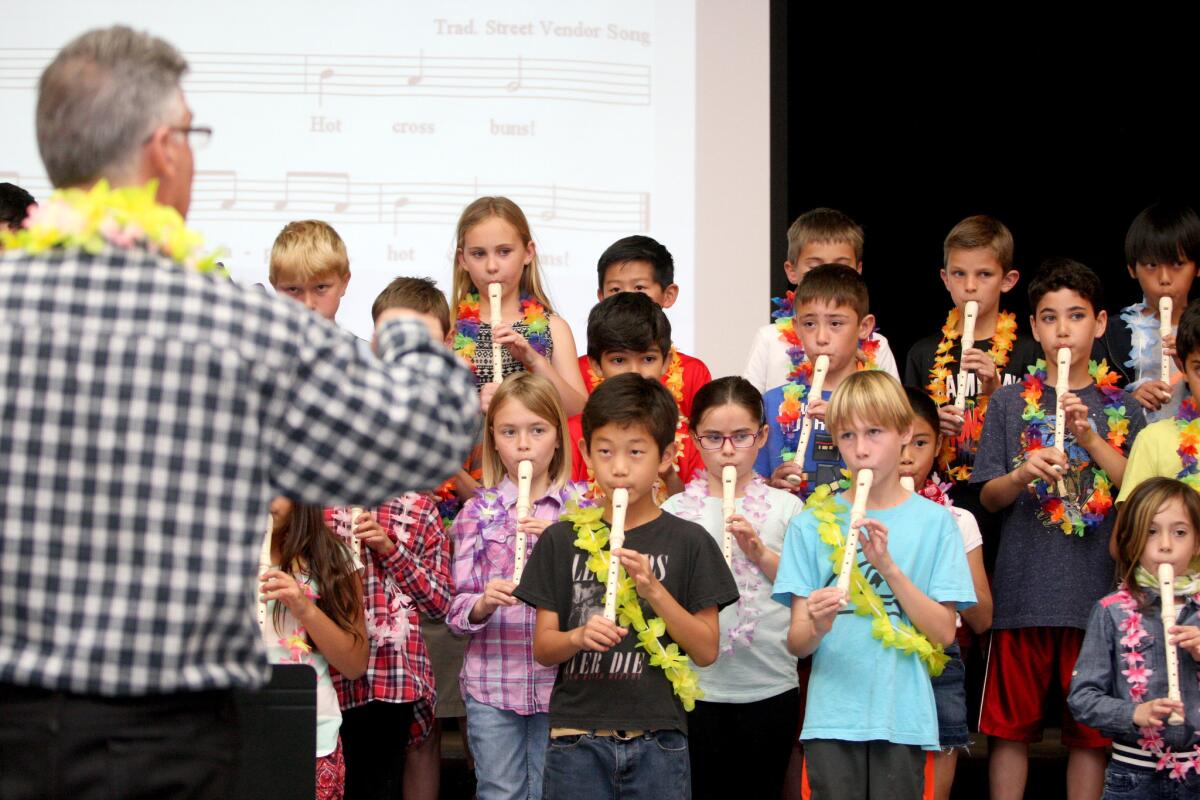 Lincoln Elementary School third-graders play recorders at the direction of second and third grade teacher Greg Mooshagian during the flag ceremony at the school in La Crescenta on Friday, Feb. 26, 2016.