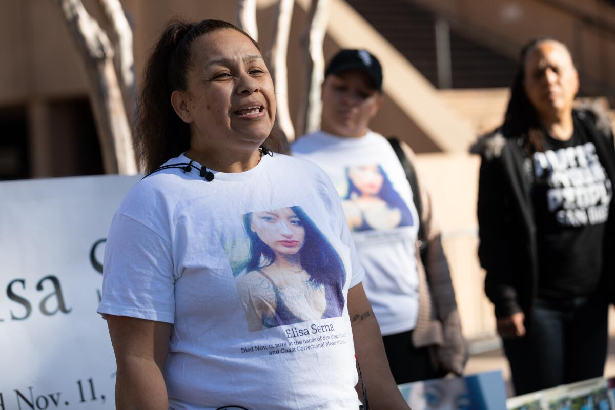 A woman speaks to members of the media.