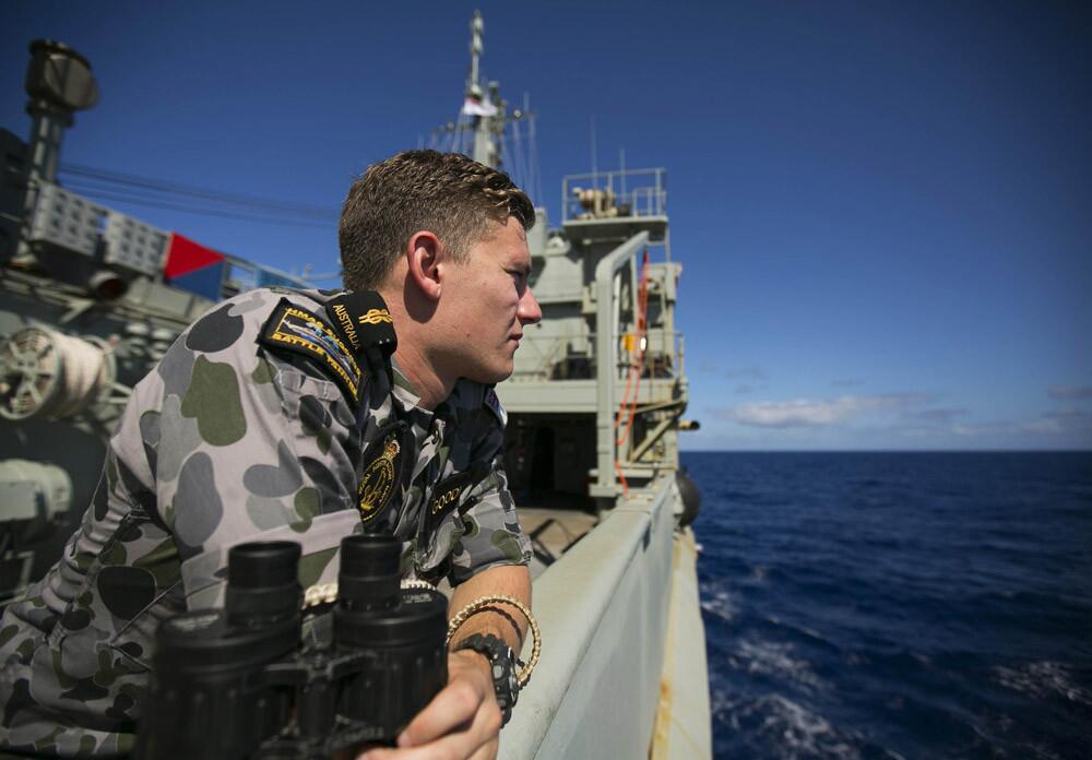 A handout photo taken on April 4, 2014 and released on April 7 by the Australian Defense shows Able Seaman Marine Technician Trent Goodman keeping lookout onboard HMAS Success during the search for missing Malaysia Airlines Flight MH370.