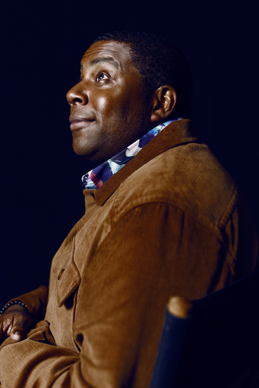 Kenan Thompson smiles and looks up in a portrait.
