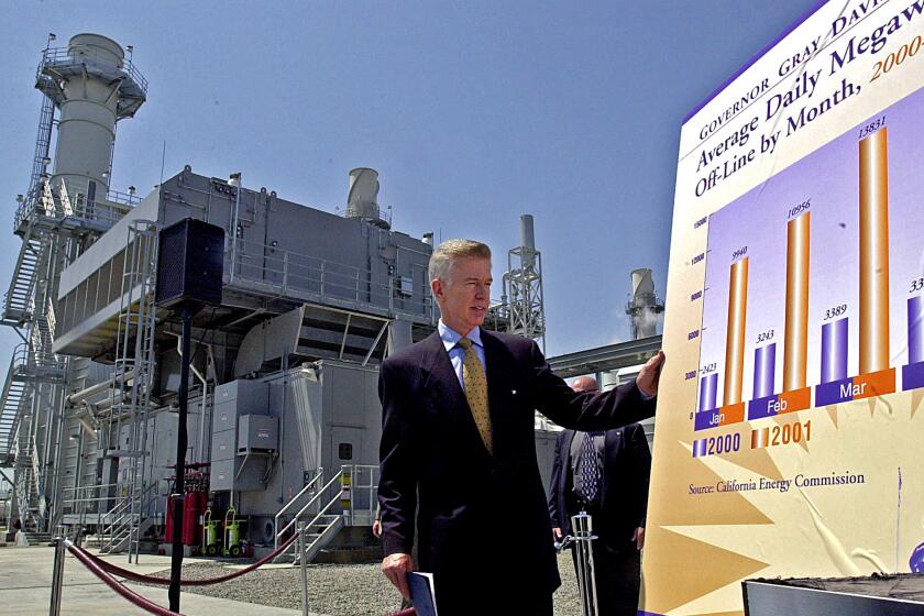 California Gov. Gray Davis, looks over a chart showing how many megawatts that have been taken off line by power generators, while at a peaker plant recently opened by the Sacramento Municipal Utility District, in Sacramento, Calif., Wednesday, May 16, 2001. Davis signed a bill, authored by State Sen. President Pro tem John Burton, D-San Francisco, that creates the California Consumer Power and Conservation Financing Authority, which gives the state the ability to construct, own and operate electric generation and power facilities and finance energy conservation programs. (AP Photo/Rich Pedroncelli)