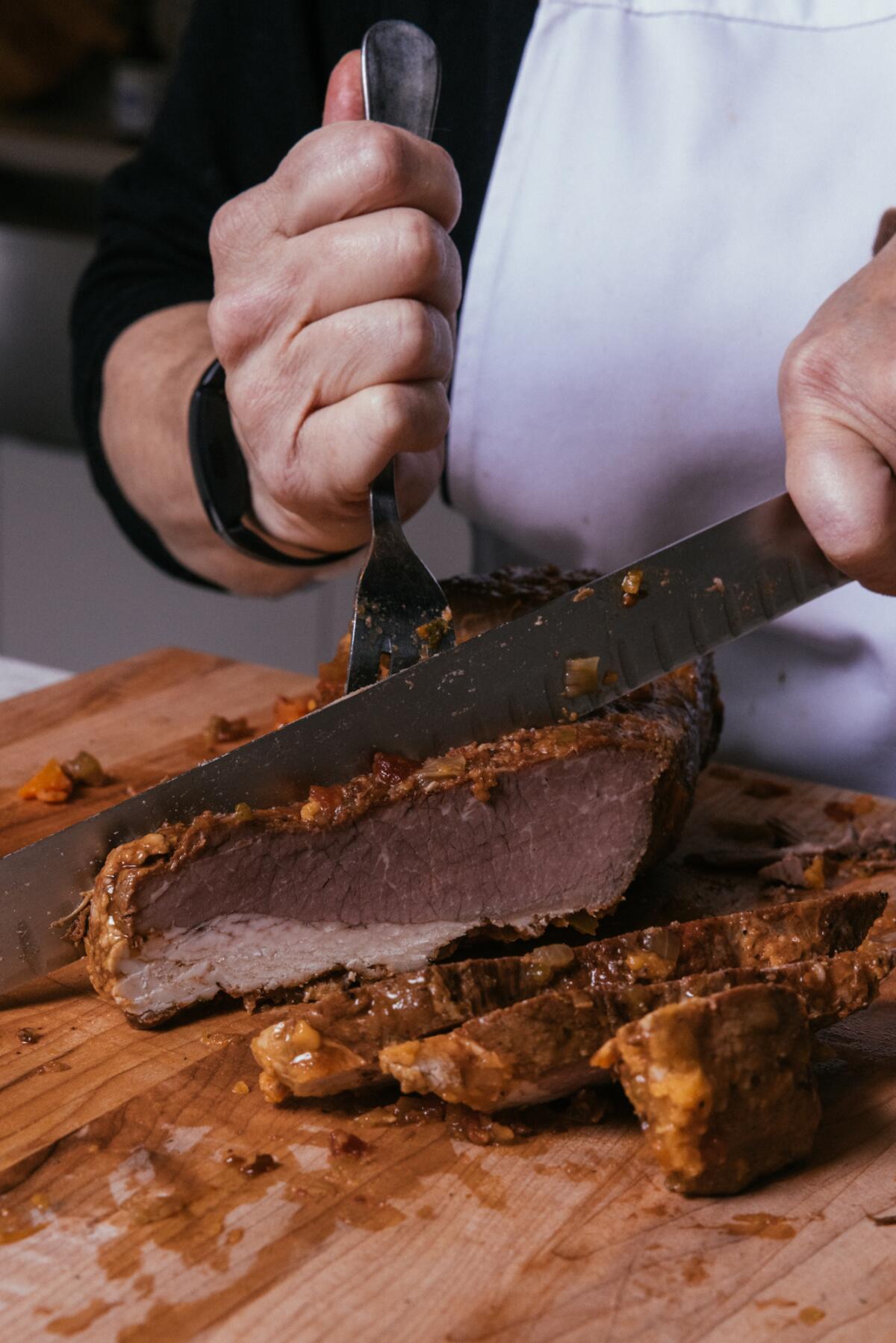 Brisket is sliced at the Los Angeles Times' studio kitchen.