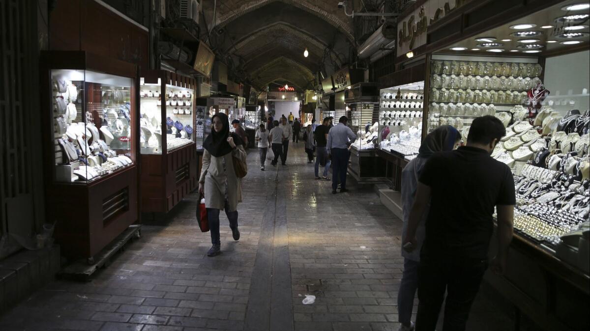 Iranians visit a gold market at the Grand Bazaar in Tehran. Prices for more mundane goods like fruit and diapers have shot up.