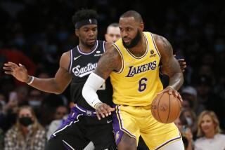 Los Angeles Lakers forward LeBron James (6) is defended by Sacramento Kings guard Terence Davis II.