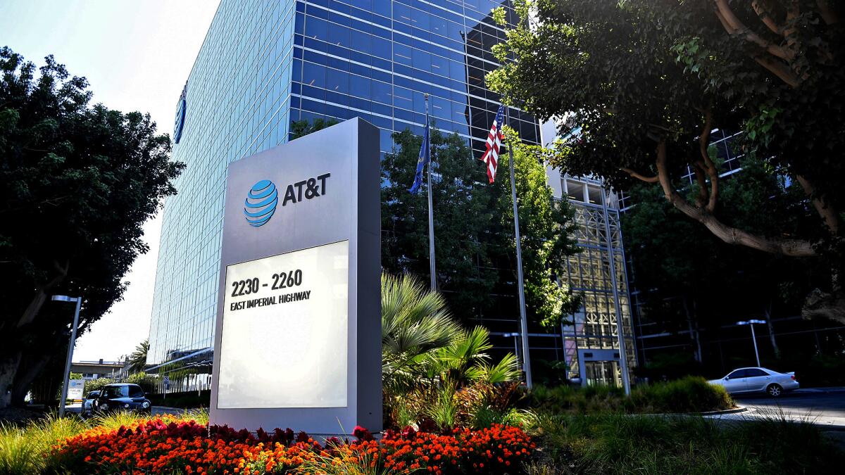 AT&T has refused the U.S. government’s demand that it divest some of the Time Warner networks or DirecTV. Above, AT&T offices in El Segundo.