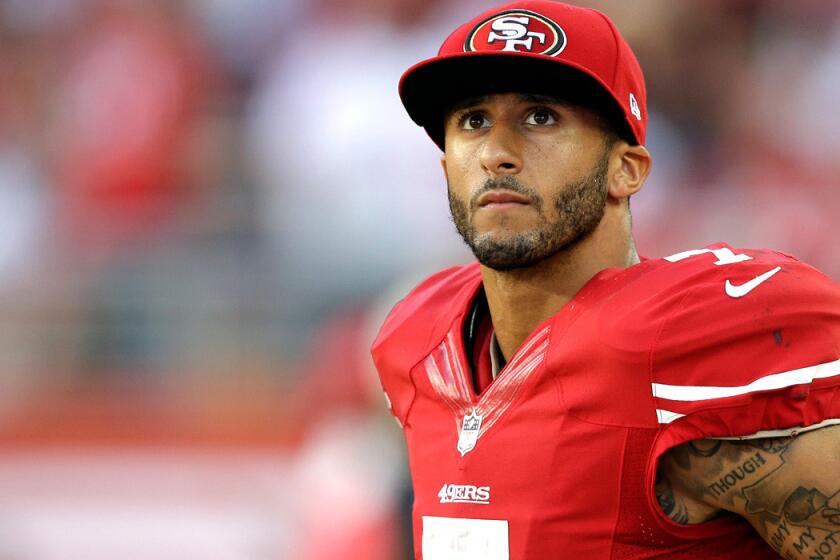 San Francisco quarterback Colin Kaepernick checks the video board in the second quarter of the 49ers' game against the Chicago Bears on Sunday evening at Levi's Stadium.