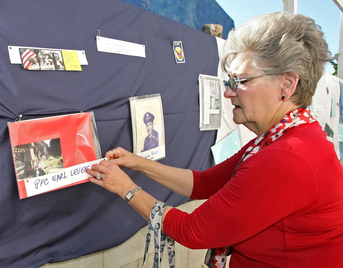 Camille Levee, former executive director of Glendale Healthy Kids who left to take a position in Arizona in 2012, has returned to the tri-city area as executive director of Women at Work in Pasadena. She is pictured putting a photo of her husband on the remembrance wall during the First Annual Veteran's Memorial Program at Wellness Works in Glendale on Saturday, May 29, 2010.