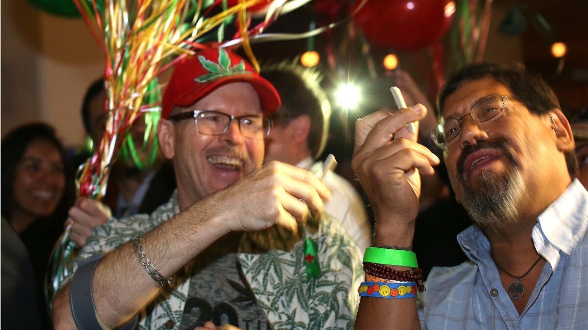 William Britt, of Long Beach, and Al Moreno, of Fullerton, both proponents of Proposition 64, the California Adult Use of Marijuana Act, celebrate a win at the DoubleTree hotel.