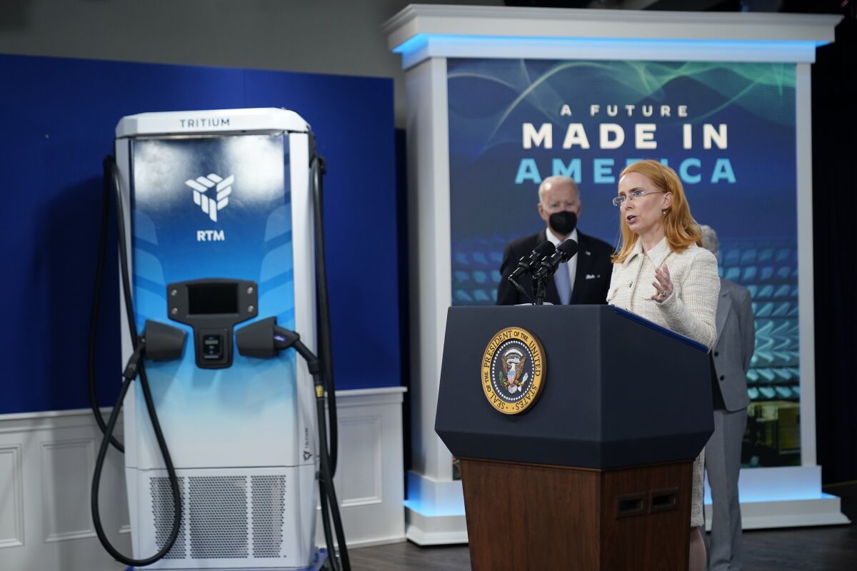 President Joe Biden listens as Jane Hunter, CEO of Tritium, speaks about electric vehicle chargers during an event in the South Court Auditorium in the Eisenhower Executive Office Building on the White House complex, Tuesday, Feb. 8, 2022, in Washington. (AP Photo/Alex Brandon)