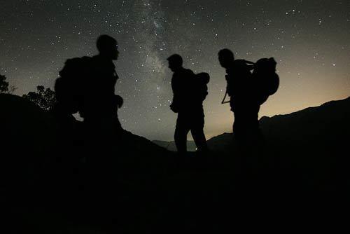 John Griffin, left, Steve McPartland and Wes Stephens, agents in the Border Patrols elite Air Mobile Unit, search for illegal immigrants a few miles north of the U.S.-Mexico border in San Diego County.