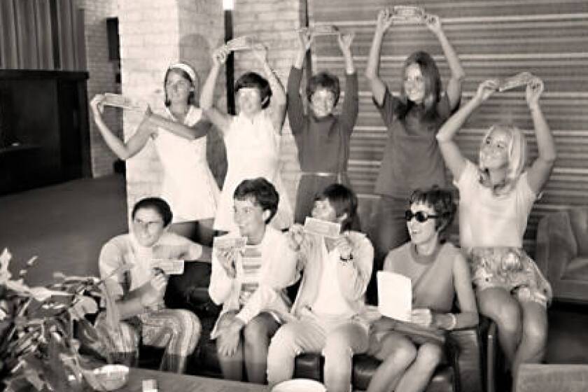 The "Original 9" women's tennis players pose with dollar bills Sept. 23, 1970, at the Houston Racquet Club. 